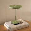UMAGE Asteria Move portable lamp in monochrome leaf green finish, shown in a lifestyle setting