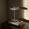 UMAGE Asteria Move portable lamp in monochrome pale blue, shown in a lifestyle setting