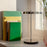 UMAGE Asteria Move portable lamp in polished steel finish, shown in a contemporary interior setup