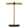 UMAGE Asteria Move portable lamp in polished brass finish, shown against a white background