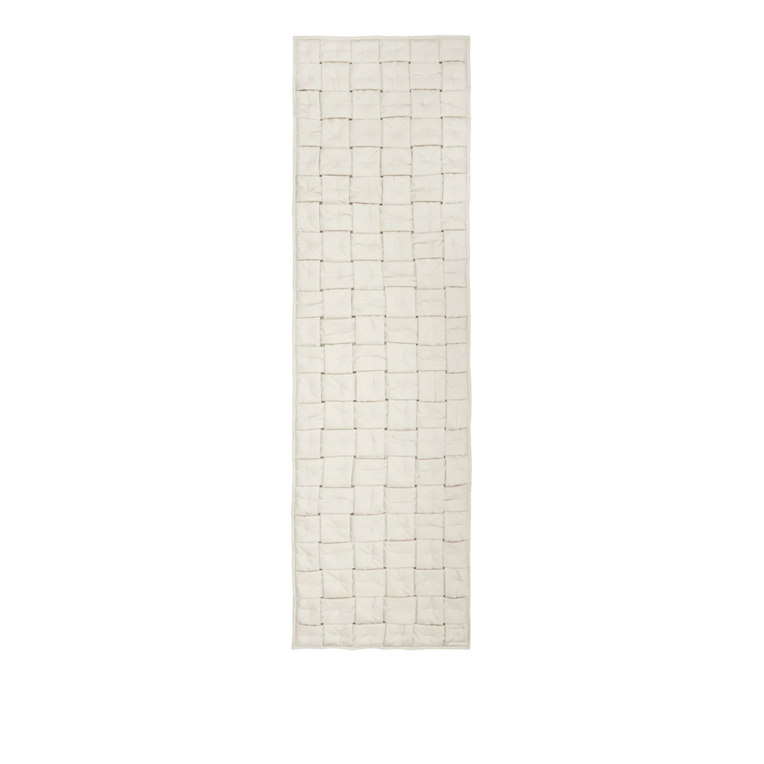 Ferm Living Sofi Bed Runner in neutral fabric, neatly draped over a modern bedroom bed for cozy, stylish decor.