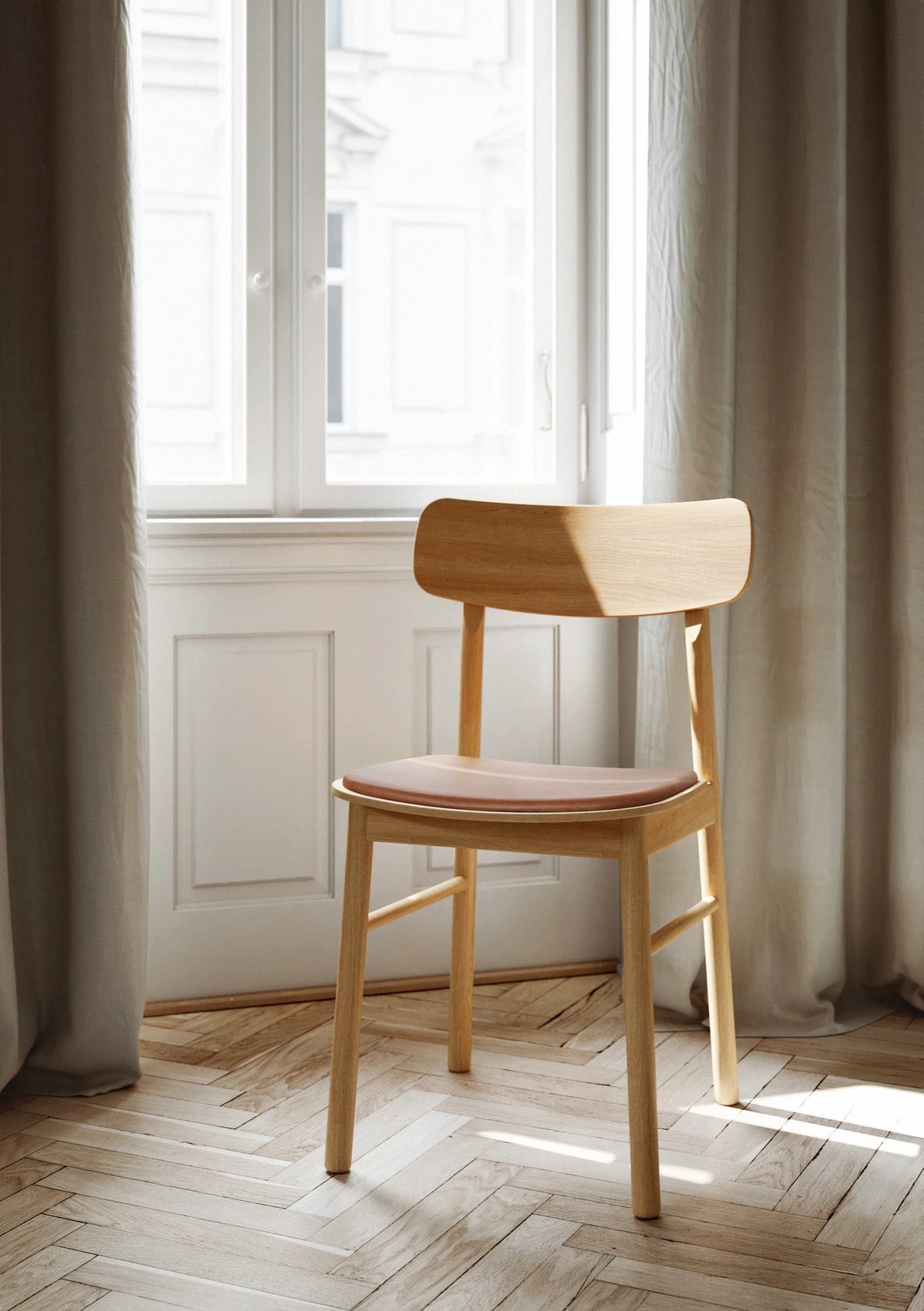 Soma dining chair by Woud Denmark featuring a modern design with wooden legs and a comfortable upholstered seat.