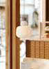 Woud Stone Pendant Glass lighting fixture hanging from ceiling, featuring a smooth stone-inspired design and clear glass shade.