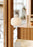 Woud Stone Pendant Glass lighting fixture hanging from ceiling, featuring a smooth stone-inspired design and clear glass shade.