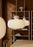 Woud Stone Pendant Glass lighting fixture hanging with a smooth stone-inspired design and clear glass shade.