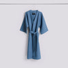 Dusty blue waffle bathrobe by Hay, soft textured accessories with a cozy, casual appearance.