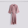 Pink waffle bathrobe by Hay with stripe design, cozy and lightweight accessories for comfortable lounging.