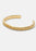 Gold plated Scale Cuff bracelet by Skultuna, showcasing a sleek, modern accessory design in a close-up view.