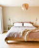 Red Birch Gladys Pendant light by Atelier Cocotte, featuring a large, modern white lampshade with a sleek design.
