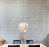 Red birch Gladys Pendant light by Atelier Cocotte, showcasing a large, elegant lighting fixture with a white interior.
