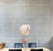 Red birch Gladys Pendant light by Atelier Cocotte, showcasing a large, elegant lighting fixture with a white interior.
