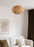White Ruth Small Pendant light by Atelier Cocotte featuring a sleek oak and birch wood design, perfect for modern lighting decor.