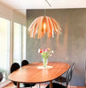 White Tina pendant light by Atelier Cocotte hanging with a sleek design, ideal for modern lighting decor.