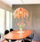 White Tina pendant light by Atelier Cocotte hanging with a sleek design, ideal for modern lighting decor.