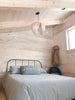 White Noisette #1 pendant light by Atelier Cocotte featuring a minimalist design and natural birch wood accents.