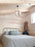 White Noisette #1 pendant light by Atelier Cocotte featuring a minimalist design and natural birch wood accents.