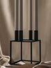 Black Kubus accessory by Audo Copenhagen, modern geometric design, made of sleek material, shown in a close-up image.