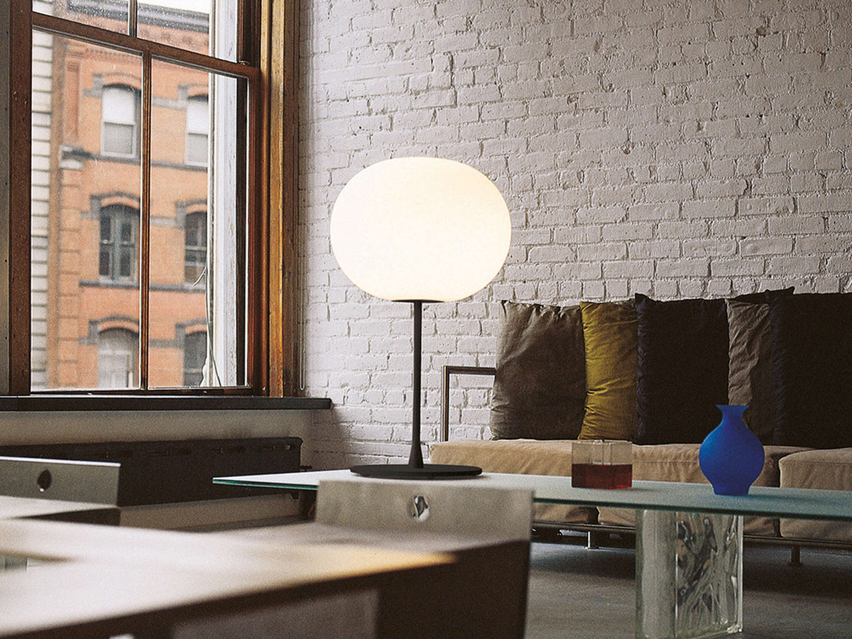 Flos Glo-Ball Table lamp with rounded glass shade and sleek base, modern lighting fixture for interior decor.