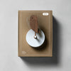 Close-up of Birdie Pro accessories packaging featuring the Birdie logo and walnut design on a sleek, modern background.