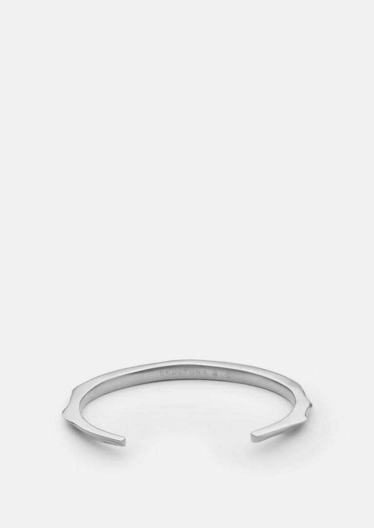 Skultuna Matte Steel Opaque Objects Cuff bracelet shown from an angled view, highlighting its sleek, minimalist design.