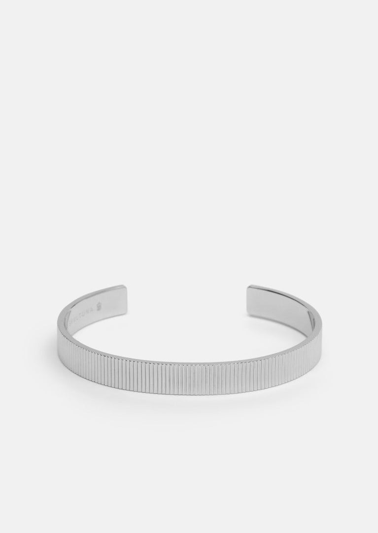 Silver plated ribbed cuff bracelet by Skultuna, featuring textured design and polished finish, shown on a neutral background.