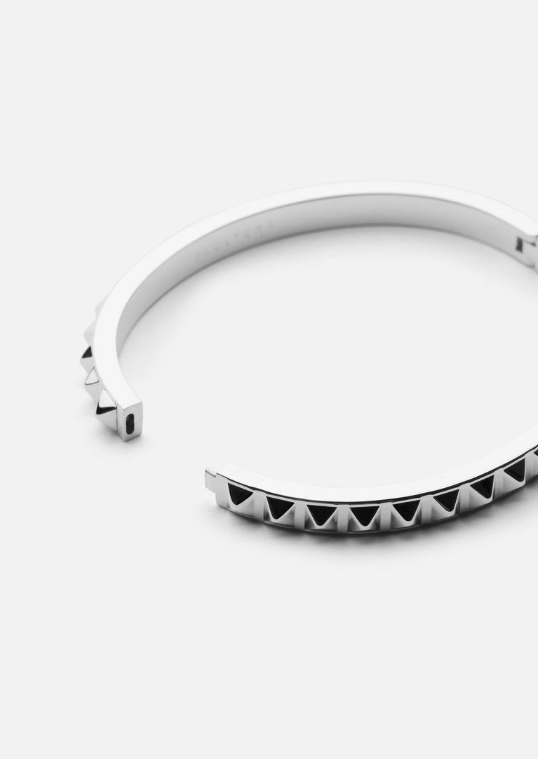 Silver plated Rivets Bangle by Skultuna, close-up of sleek, minimalist jewelry accessory with rivet details on a plain background.