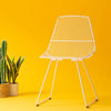Ethel Chair by Bend Goods featuring a modern, open metal frame with a sleek, minimalist design for stylish seating.