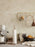 Brass Curvature Paper Towel Holder by Ferm Living, modern kitchen accessory with sleek curved design and sturdy base.