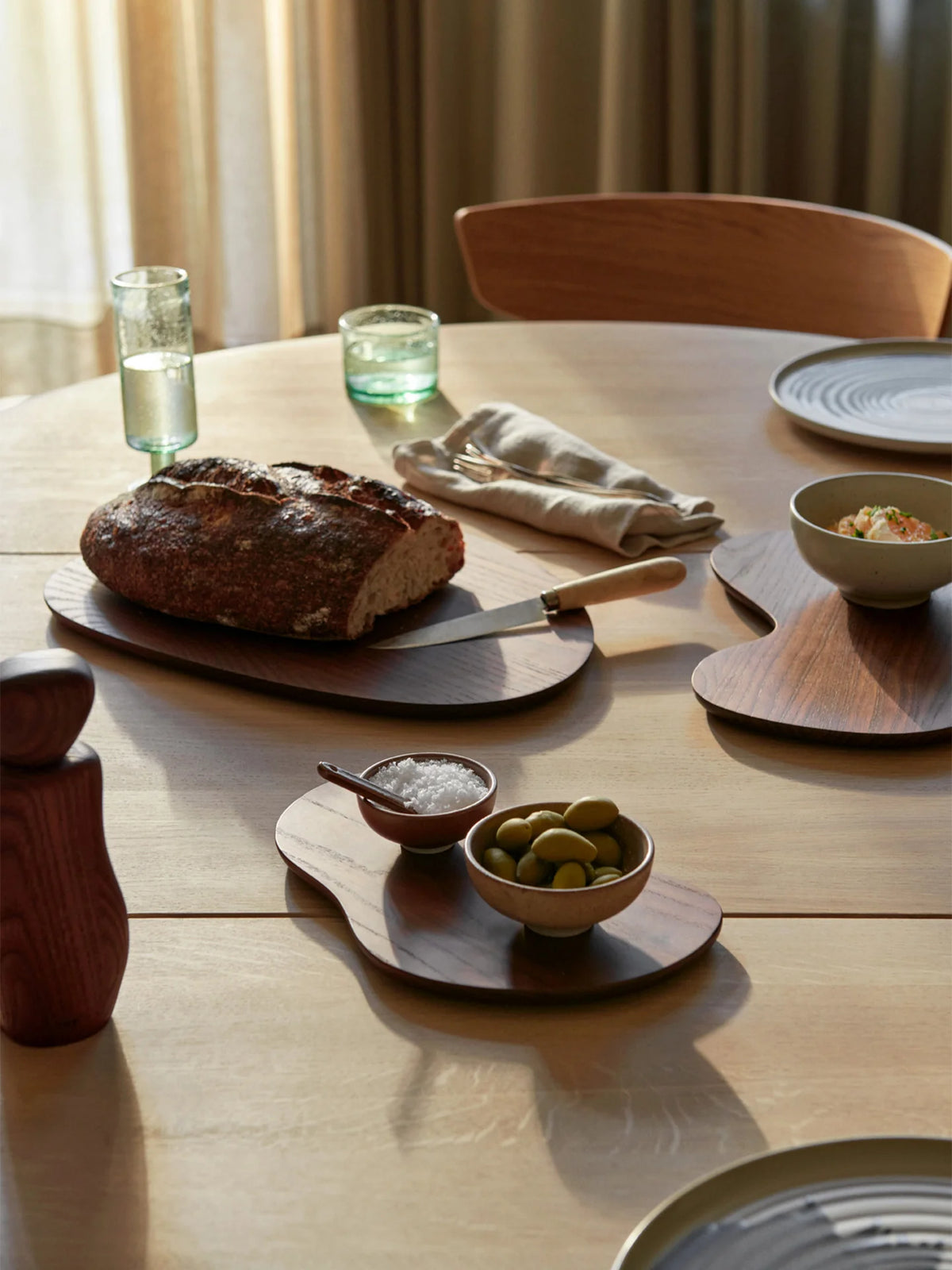 Dark brown Ferm Living Cairn cutting boards, stylish wooden kitchen accessories with a modern geometric design.
