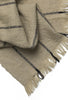 Ferm Living Calm Blanket in soft, neutral fabric, styled as cozy home accessory with textured weave and fringed edges.
