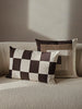 Fold patchwork cushion by Ferm Living featuring undyed fabric in green and natural tones, showcasing a cozy, textured accessory for home decor.