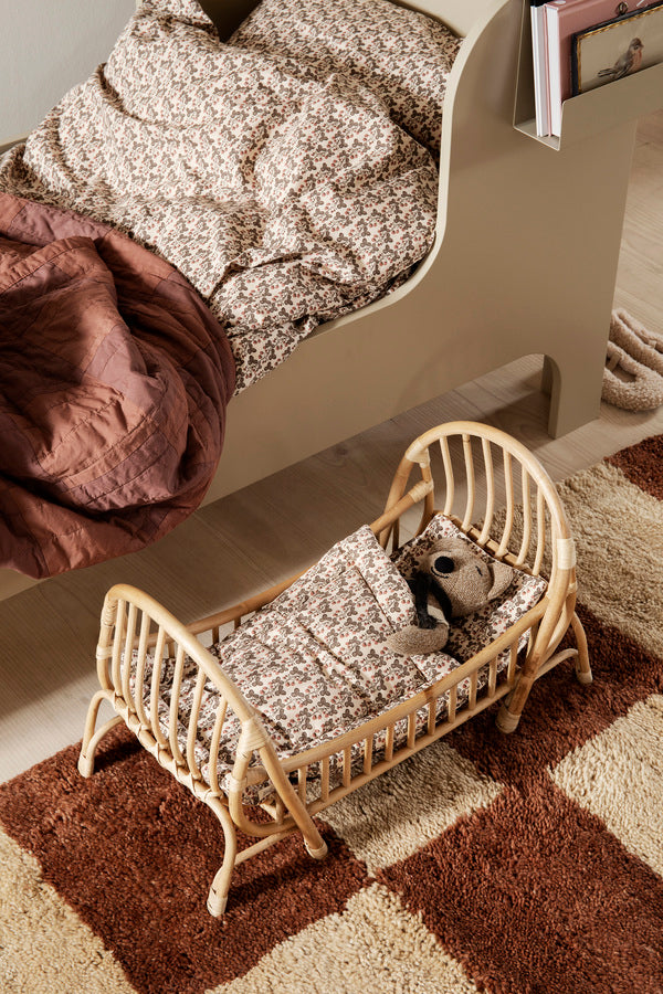 Ferm Living Kuku Doll Bed for kids, featuring a cozy wooden doll bed with soft bedding and charming design.