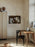 Black Ferm Living Herman Dining Chair with wooden legs, showcasing modern seating design and sleek craftsmanship.
