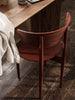 Black Herman Dining Chair by Ferm Living, wooden seat and backrest, modern Scandinavian-style seating for dining rooms.