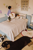 Kids' Apple-shaped floor cushion by Lorena Canals, soft fabric and colorful design for children's room decor.