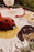 Kids floor cushion featuring Maria the Ladybug by Lorena Canals, soft fabric with red and black ladybug design, ideal for children's rooms.