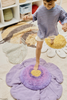 Kids purple Poppy floor cushion by Lorena Canals, soft fabric with floral design, perfect for cozy play and relaxation.