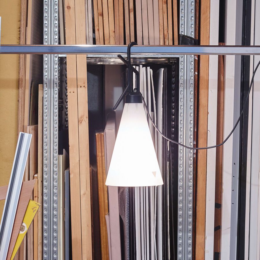 Black Mayday lamp by Flos, modern lighting fixture with sleek design, featuring a rounded shade and minimalist stand.