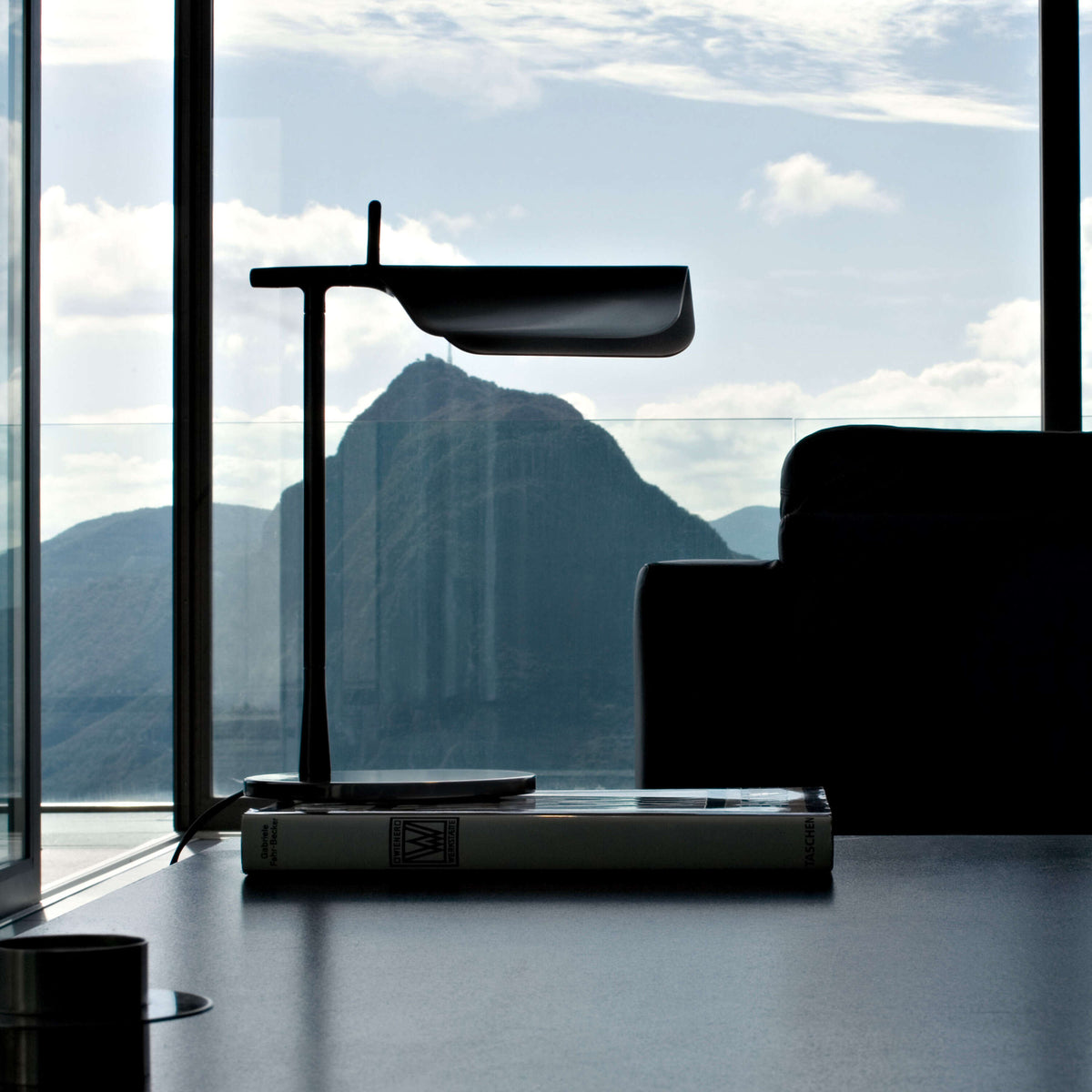 Black Flos Tab Table lighting with sleek, modern design, featuring a rounded tabletop and minimalist base.