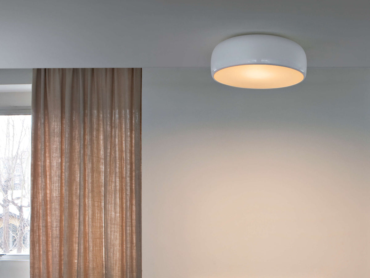 Black Smithfield ceiling light by Flos, modern LED lighting fixture with 2700K warm glow, designed for stylish interior illumination.