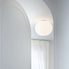 Modern Glo-Ball ceiling lighting fixture by Flos, featuring a smooth, spherical white glass shade for ambient illumination