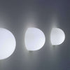Modern Glo-Ball Wall lighting fixture by Flos, sleek frosted glass globe mounted on a wall bracket for ambient illumination