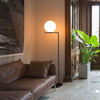 Black IC Lights Floor by Flos, modern lighting fixture with sleek design, standing on a flat surface with a minimalist aesthetic.