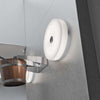Mini Button lighting fixture by Flos featuring a sleek, compact design with a round, minimalist shape and a smooth surface.