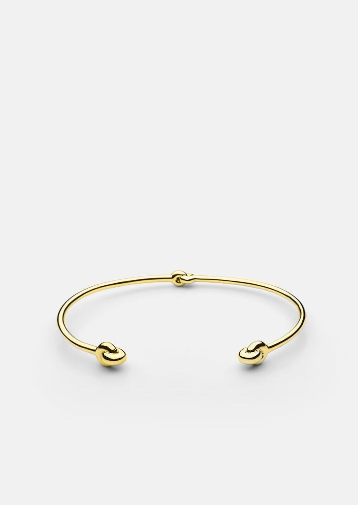 Gold-plated Knot Cuff accessory by Skultuna featuring a sleek, elegant knot design on a polished gold finish.