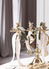 Skultuna Mistel candleholder in brass with a modern, minimalist design, displayed on a wooden surface.