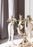 Skultuna Mistel candleholder in brass with a modern, minimalist design, displayed on a wooden surface.