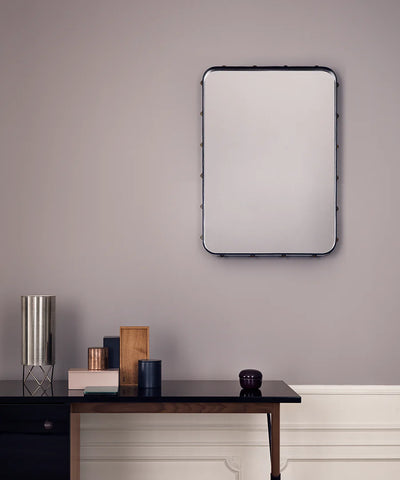 Rectangular Gubi Adnet Wall Mirror with black leather frame, showcasing a sleek, modern accessory for stylish interior decor.
