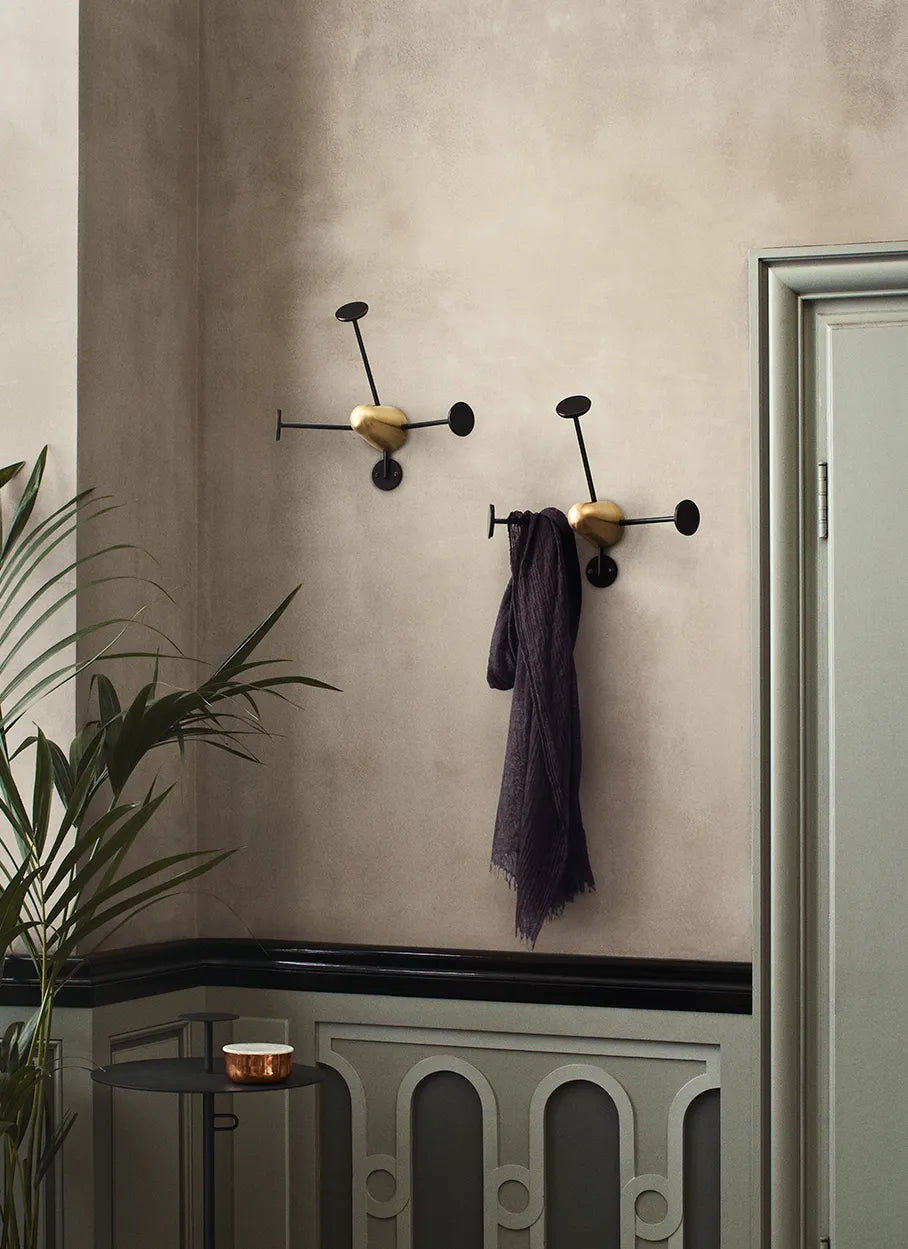 Gubi Matégot coat rack in ochre with a vintage-inspired design, showcasing its unique metal and rattan construction.