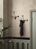 Gubi Matégot coat rack in ochre with a vintage-inspired design, showcasing its unique metal and rattan construction.